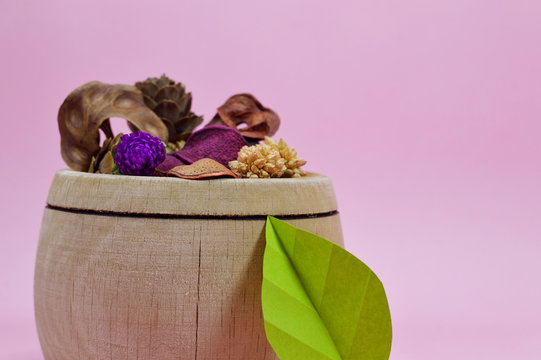 dried potpourri in wooden bowl front view