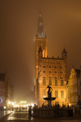 Main Town Hall in Old Town of Gdansk in the fog at night. Poland.