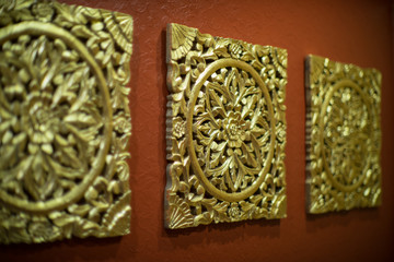 Wall decoration. A carved pattern of wood in gold.