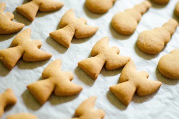 Set of Christmas theme shaped cookies on white cooking paper background. Ange, snowman and fish
