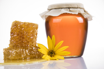 Sweet honey in the comb, glass jar
