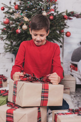 Boy new year with presents in hands