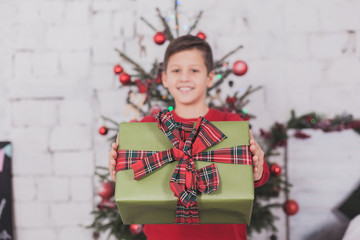 Boy new year with presents in hands