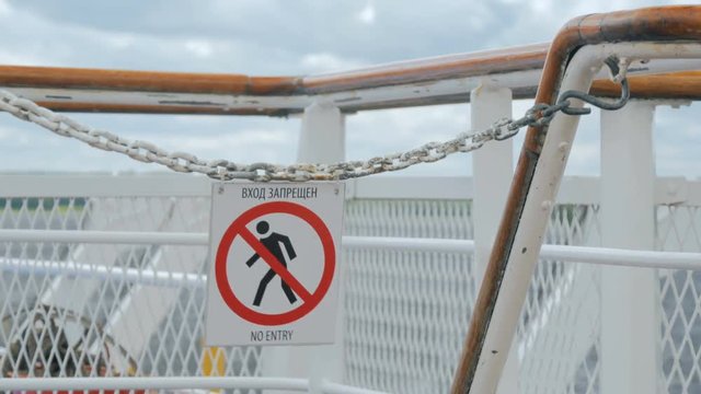 No Entry Sign on deck of cruise ship in Russia. Blows in the wind. Russian and english language. No Public Access