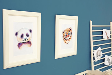 Pictures of animals on wall in baby room
