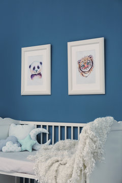 Baby bedroom with pictures of animals on wall