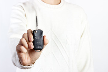 hand hold car key on white backgrounds