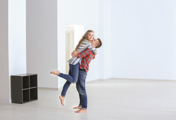 Young couple in room at new home