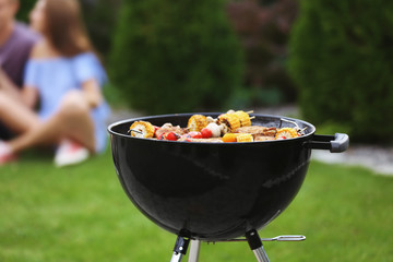 Tasty steaks and vegetables cooking on barbecue grill, outdoors