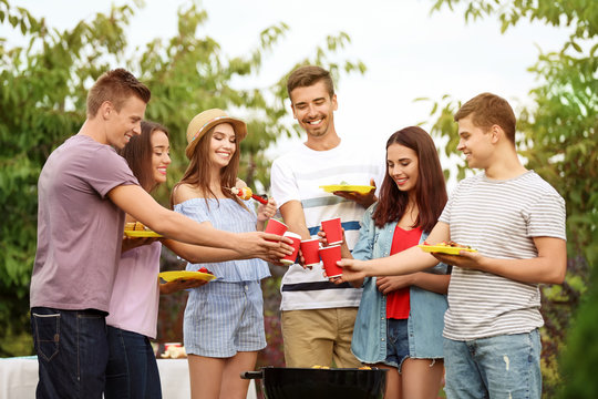 Young friends having barbecue party in garden