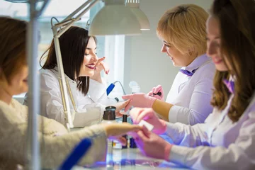Fotobehang Masters of manicure at work in the beauty salon. Hand care © pavelkriuchkov