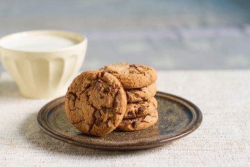Cup of hot milk and homemade chocolate chip cookies