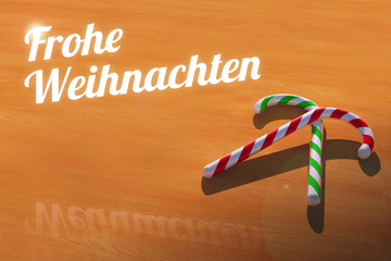 Frohe Weihnachten with Candy Canes on Wooden Table Greeting Card