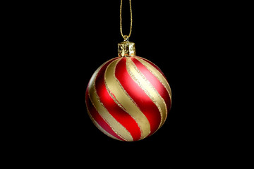 Red and Yellow Christmas Tree Ornament, ball, decorations. Isolated black background.