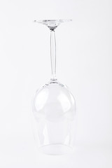 Large glass for wine upside. Crystal glass for wine isolated on white background upide down.