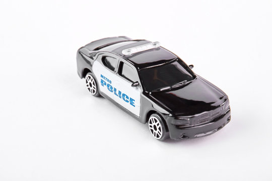 Metro police car toy, white background. Black and white metal police car toy isolated on white background.