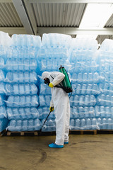 Pest Control Worker Hand Holding Sprayer For Spraying Pesticides in production or manufacturing factory