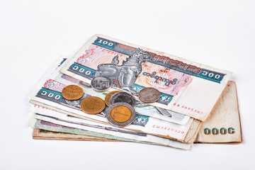 Myanmar banknotes and coins. Myanmar kyat currency and metal coins on white background.