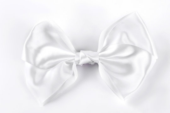 White Bow Tie On White Background. White Accessory For Girls Hair Isolated On White Background.