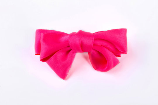 Pink bow tie on white background. Beautiful accessory for girls hair isolated on white bakground. Kids elegant hair accessory.