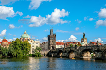 Fototapeta na wymiar Beautiful view from the river Vltava on the Bank of Prague on a Sunny day with a dramatic sky.