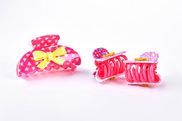 Pink plastic hair clips. Kids cute pink hair clips with yellow bow on white background. Little girls hair accessories.