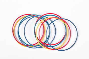 Colored plastic bracelets on white background. Collection of hand bangles of different colors on white background.