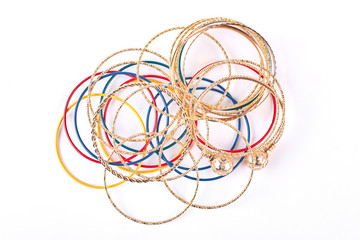 Collection of fashion bracelets, top view. Plastic and golden bangles on white background. Hand accessories for women.