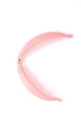 Hair comb banana clip. Pink plastic hair clip isolated on white background.