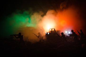 Obraz na płótnie Canvas War Concept. Military silhouettes fighting scene on war fog sky background, World War Soldiers Silhouettes Below Cloudy Skyline At night. Attack scene. Armored vehicles. Selective focus