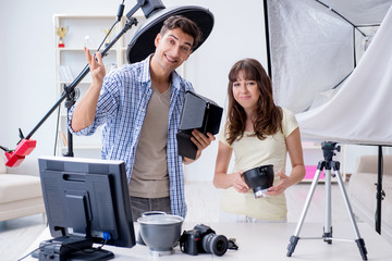 Young photographer working in photo studio