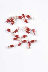 Scattered capsules on white background. Pile of colored pills isolated on white background, top view.