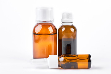 Bottles with medicine, nasal spray. Cough syrup, antipyretic syrup and nose drops on white background. Medication for cold treatment.