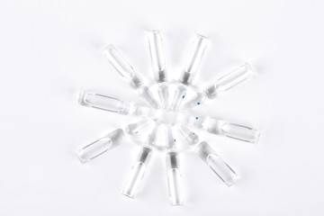 Set of transparent medical ampoules. Break-seal glass ampoules set on white background, top view.