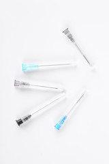 Set of medical syringe needles. Group of disposable hypodermic needles on white background, top view.