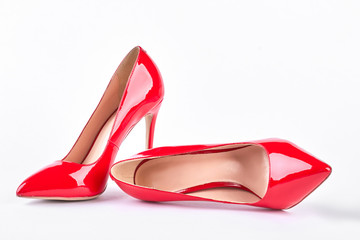 Classic red shoes on high heels. Woman red elegant shoes on heels over white background. Female...