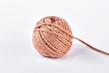 Ball of brown yarn, white background. Ball of yarn for knitting, isolated on white background.