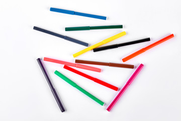 Colored markers, top view. Multicolored markers on white background. Tools for drawing at school.