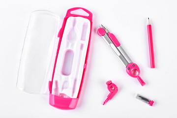 Pink pair of drawing compasses. Stationery on white background. Equipment of an architect.