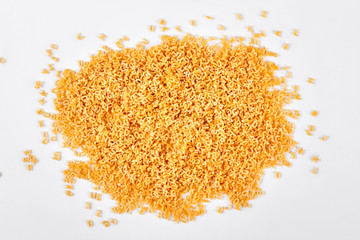 Heap of stelline italian pasta. Italian little pasta letters stelline over white background.