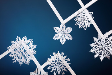 Winter style background.Paper snowflakes on blue background.Greeting card
