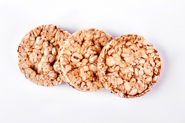 Three cereal crackers on white background. Wholegrain crispbreads on white background, top view. Puffed dietary crackers.