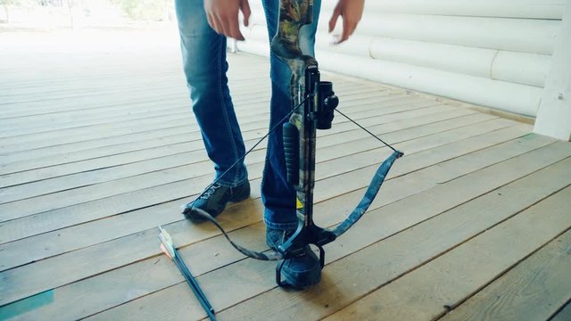 Two men pull the strings of the crossbows