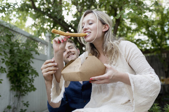Couple eating churros together