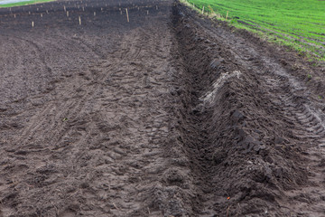 ploughed agriculture field with dark soil