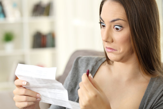 Shocked woman reading contraindications of a leaflet of a capsule