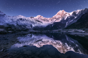 Amazing night scene with himalayan mountains and mountain lake at starry night in Nepal. Landscape...