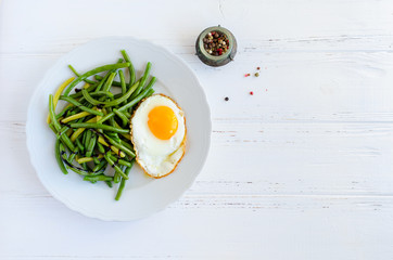 Cooked green beans with fried egg