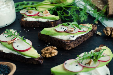 Sandwiches of rye bread with avocado and goat cheese