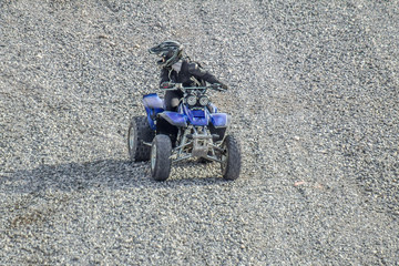 Riding on the ATV on gravel